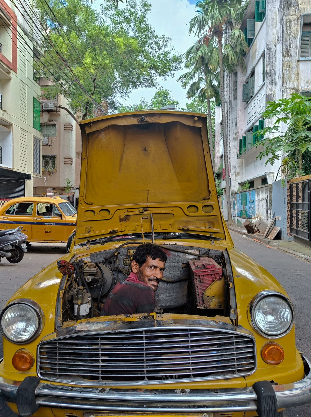 Mechanic working on an Ambassador car