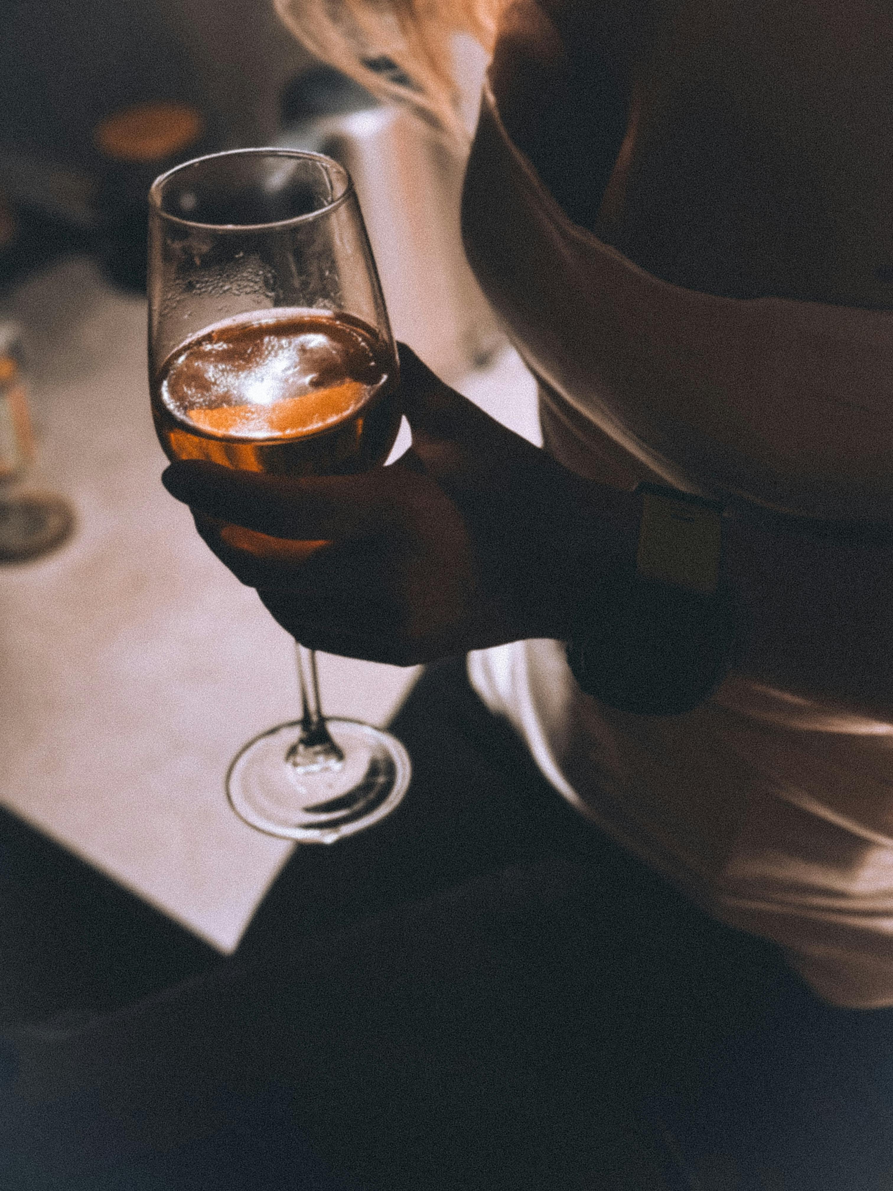 a woman holding a glass of wine in her hand