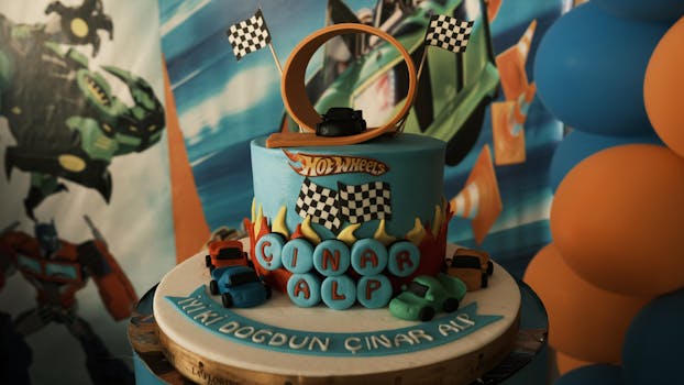 Vibrant Hot Wheels birthday cake with toy cars and a loop track, perfect for a child's party.