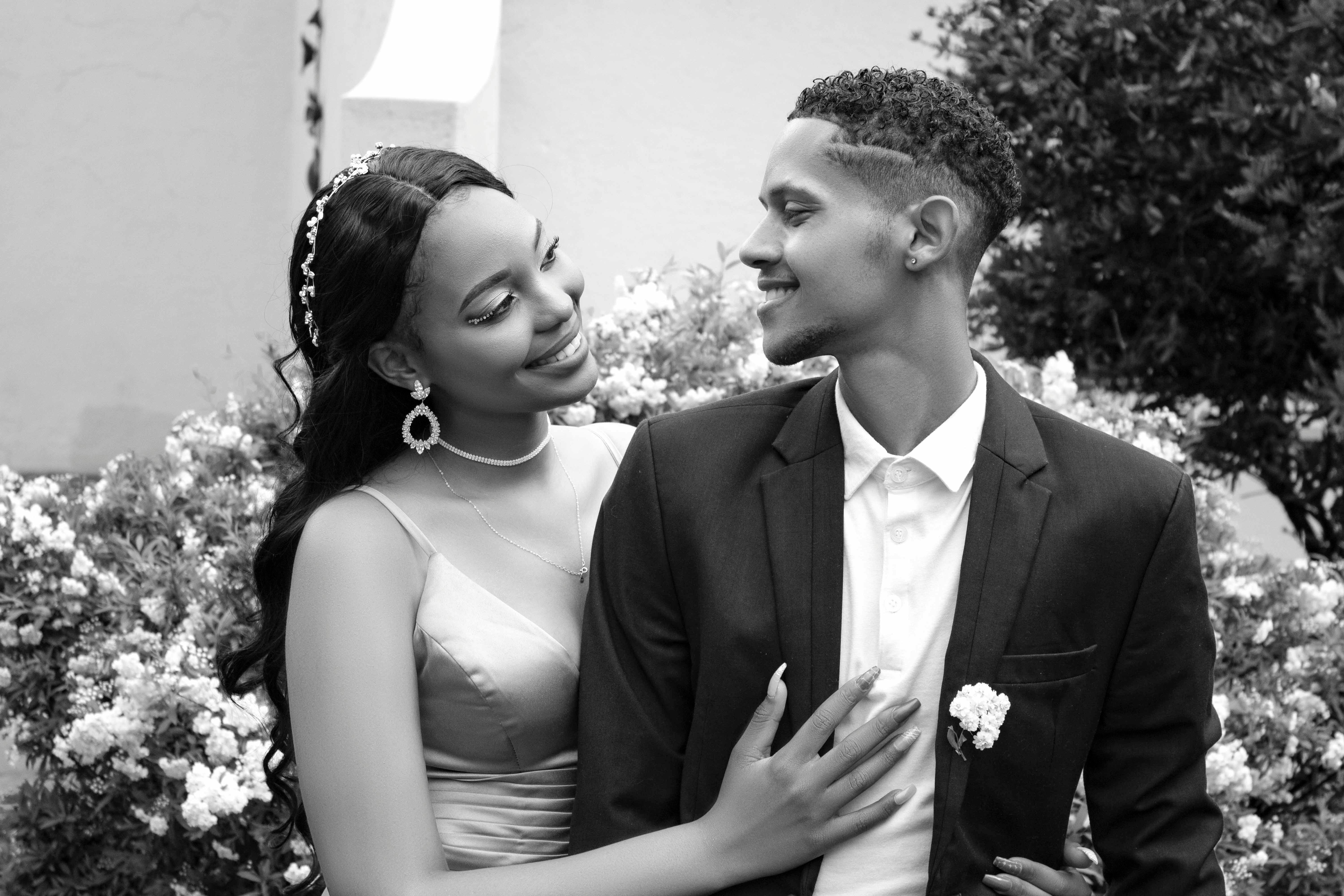 a black and white photo of a couple in formal attire