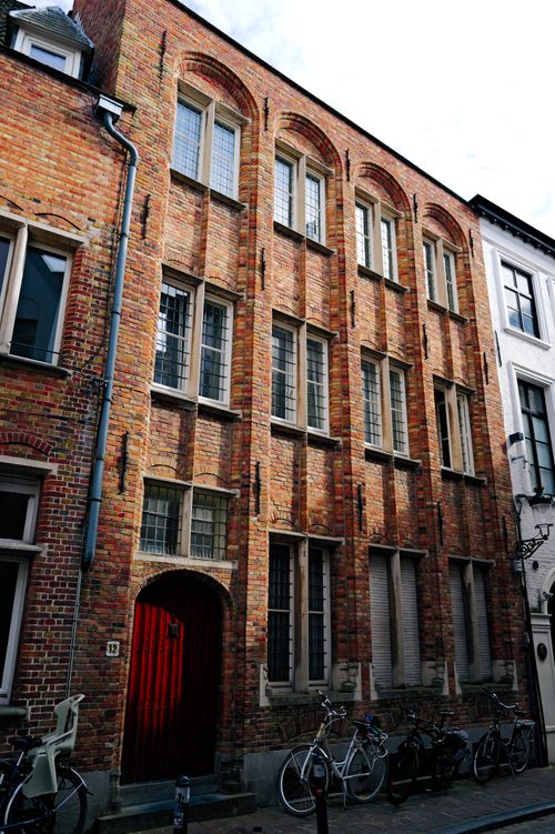 Free Exterior view of a vintage brick building with arched windows in a European street. Stock Photo