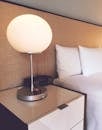 Silver and White Desk Lamp Beside Bed