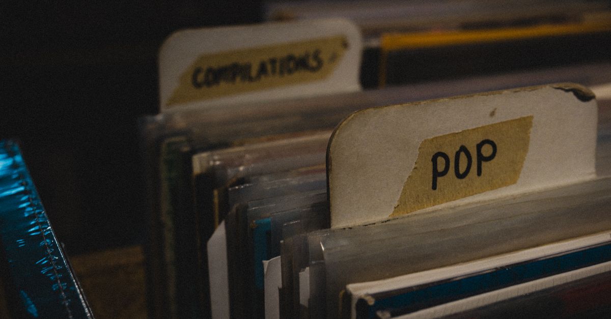 Crowd of young people at a Record Store Day event flipping through vinyl bins