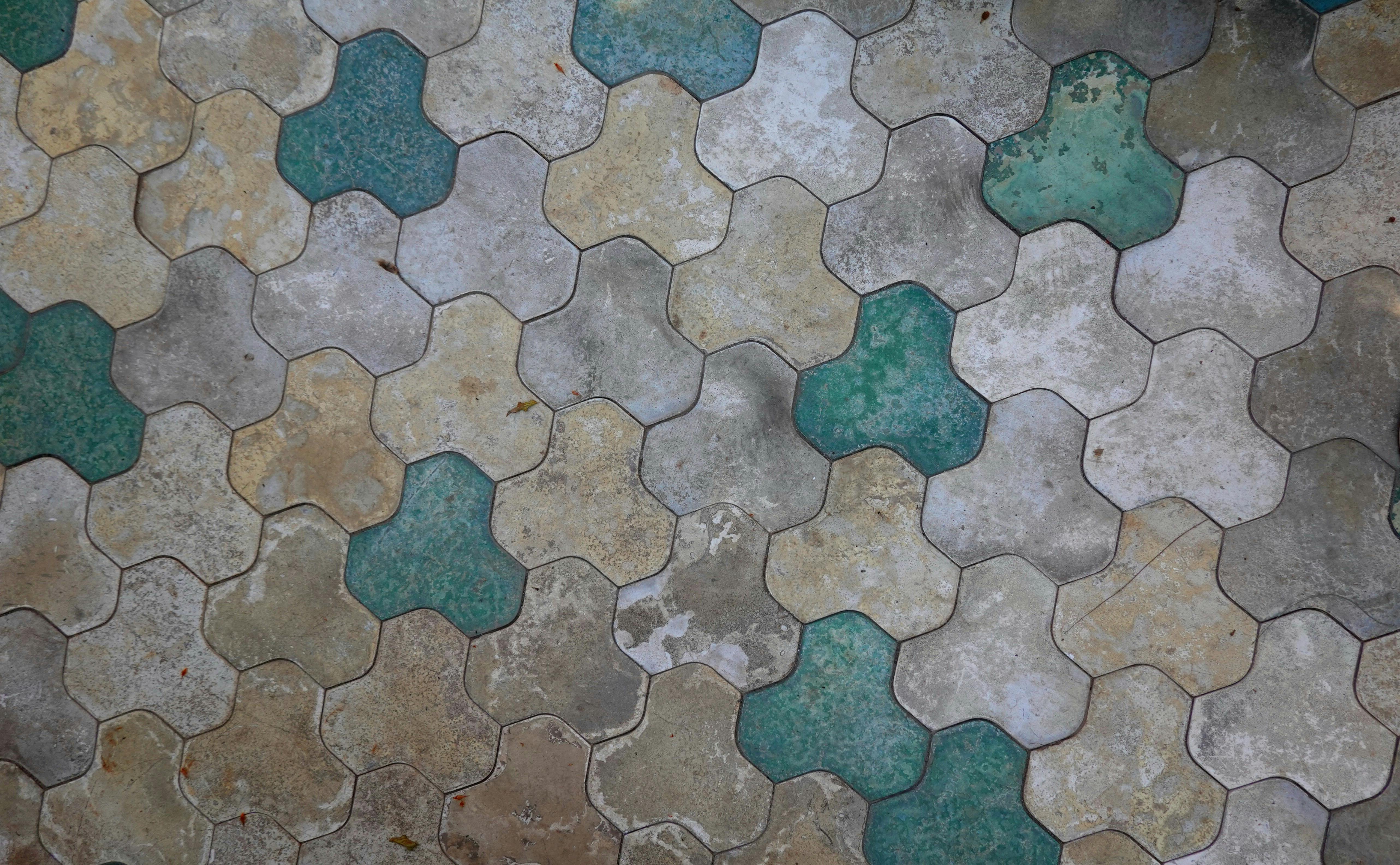 a tile floor with green and blue tiles