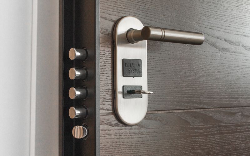 Professional locksmith working on a door lock