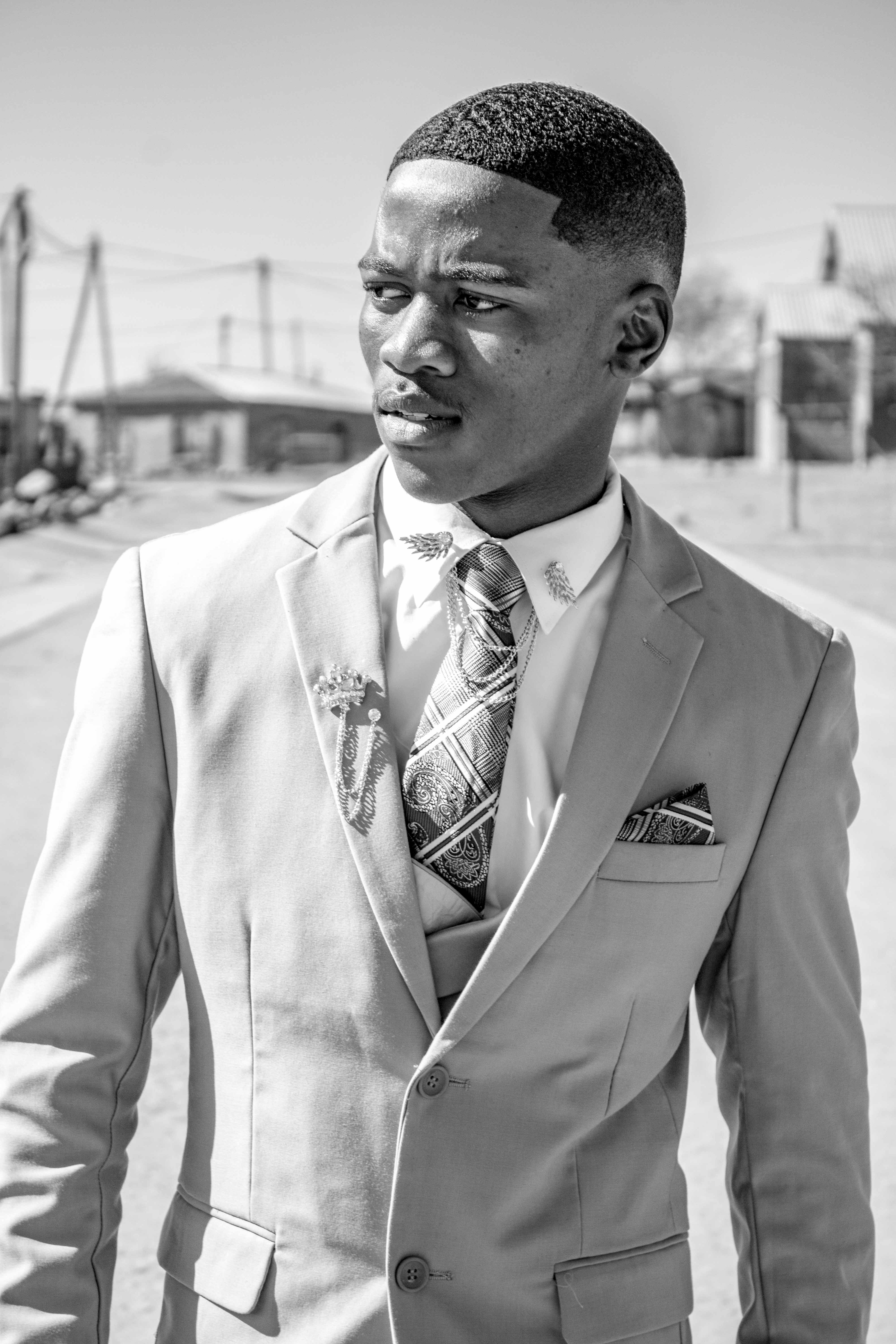A man in a suit and tie standing in the street · Free Stock Photo