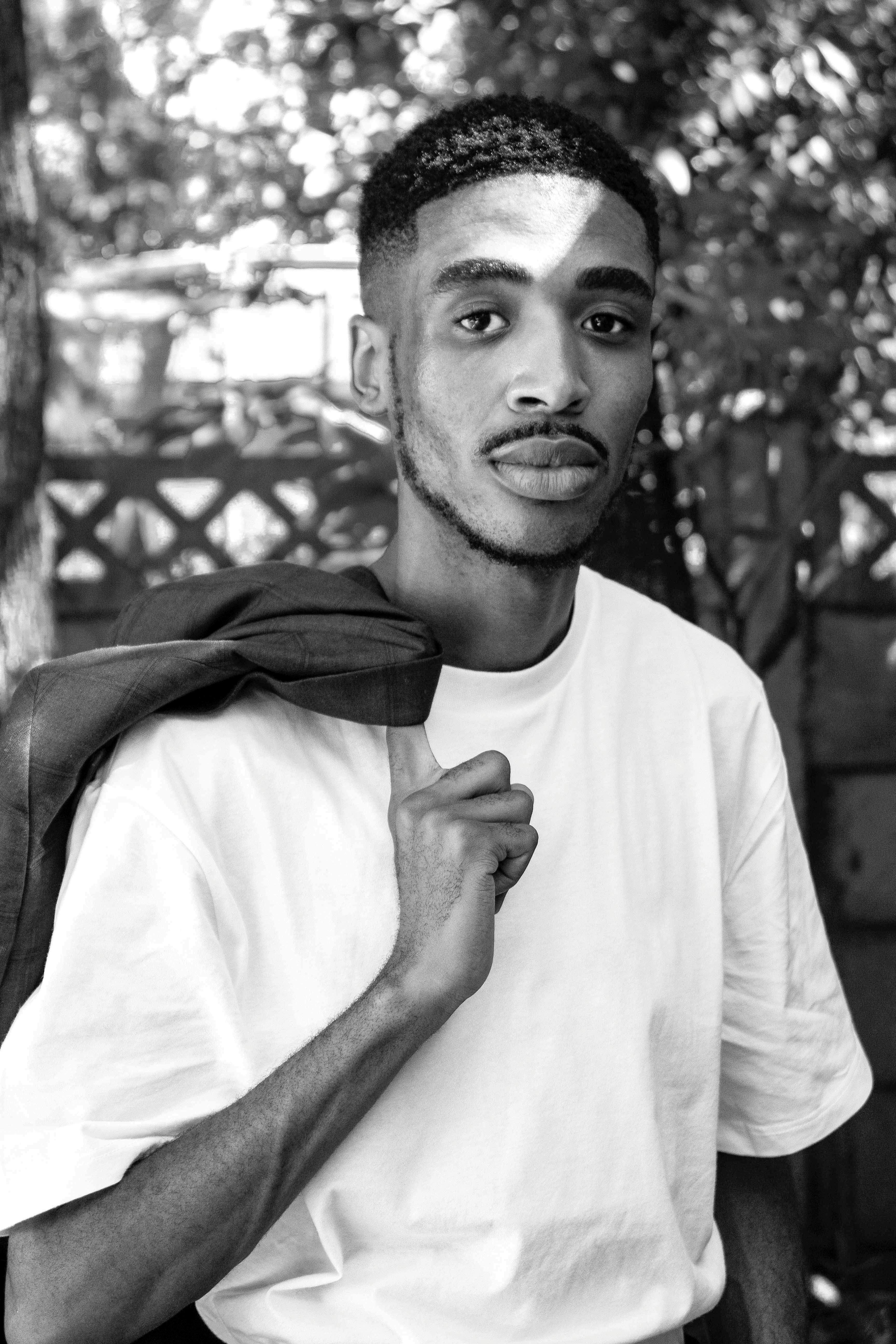 a black and white photo of a man in a white shirt