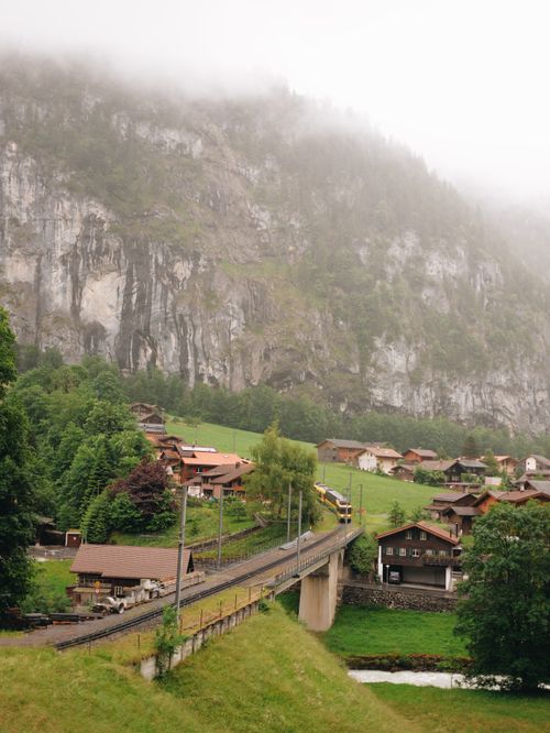 Free Charming village in Lauterbrunnen, Switzerland, surrounded by mountains and clouds. Stock Photo