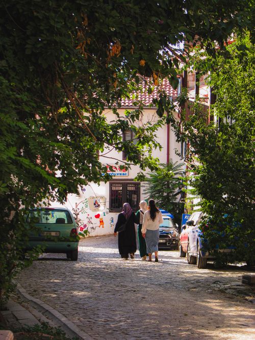 Free A picturesque street scene in Ankara, Türkiye, featuring a group walking through a tree-lined road. Stock Photo