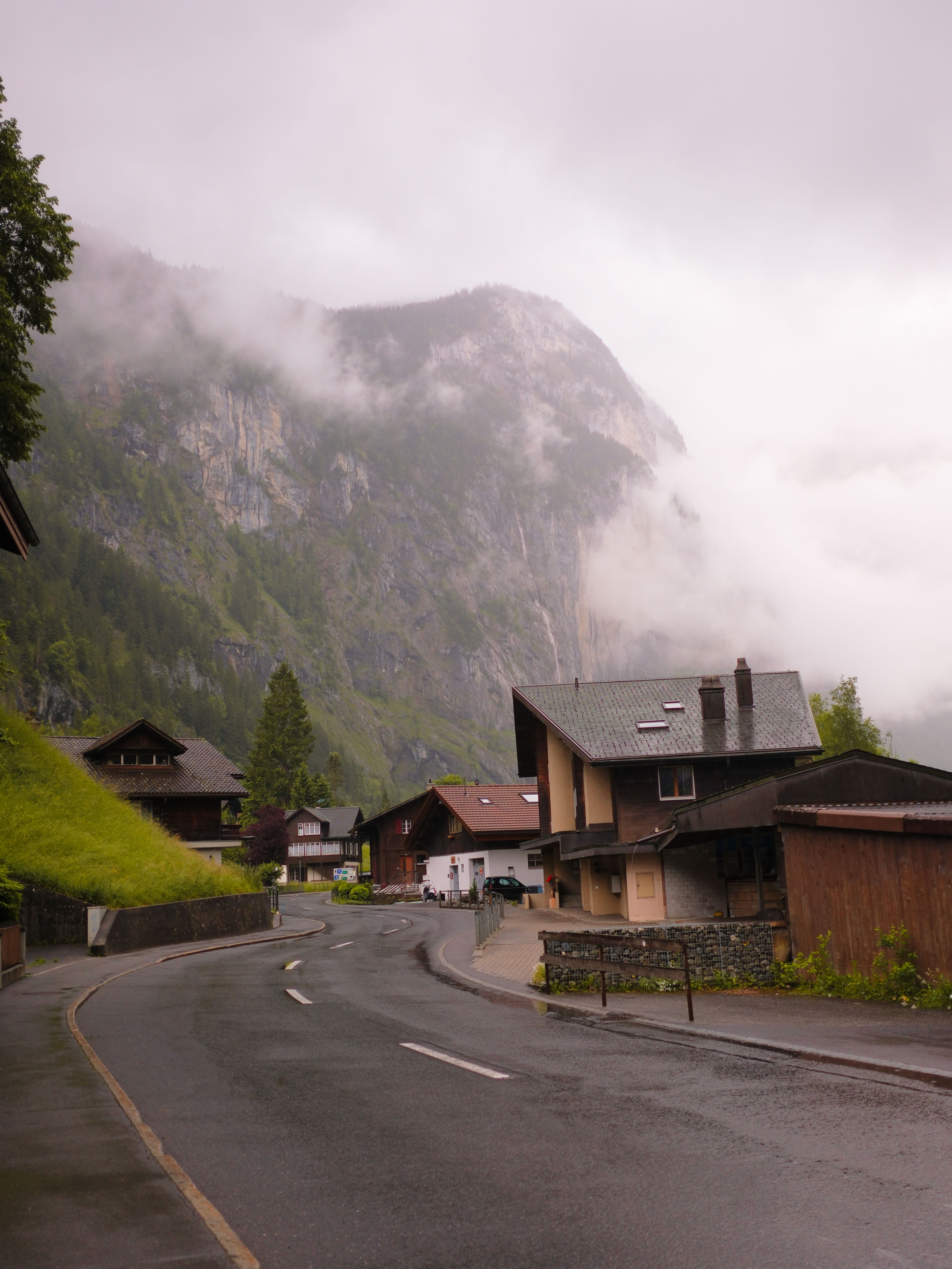 A mountain road with houses and trees on it · Free Stock Photo
