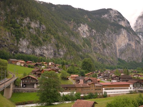 Free Lauterbrunnen village nestled amidst the Swiss Alps, showcasing charming chalets and stunning mountain views. Stock Photo