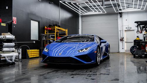 Free A stunning blue Lamborghini Huracan parked indoors showcasing its sleek design and modern style. Stock Photo