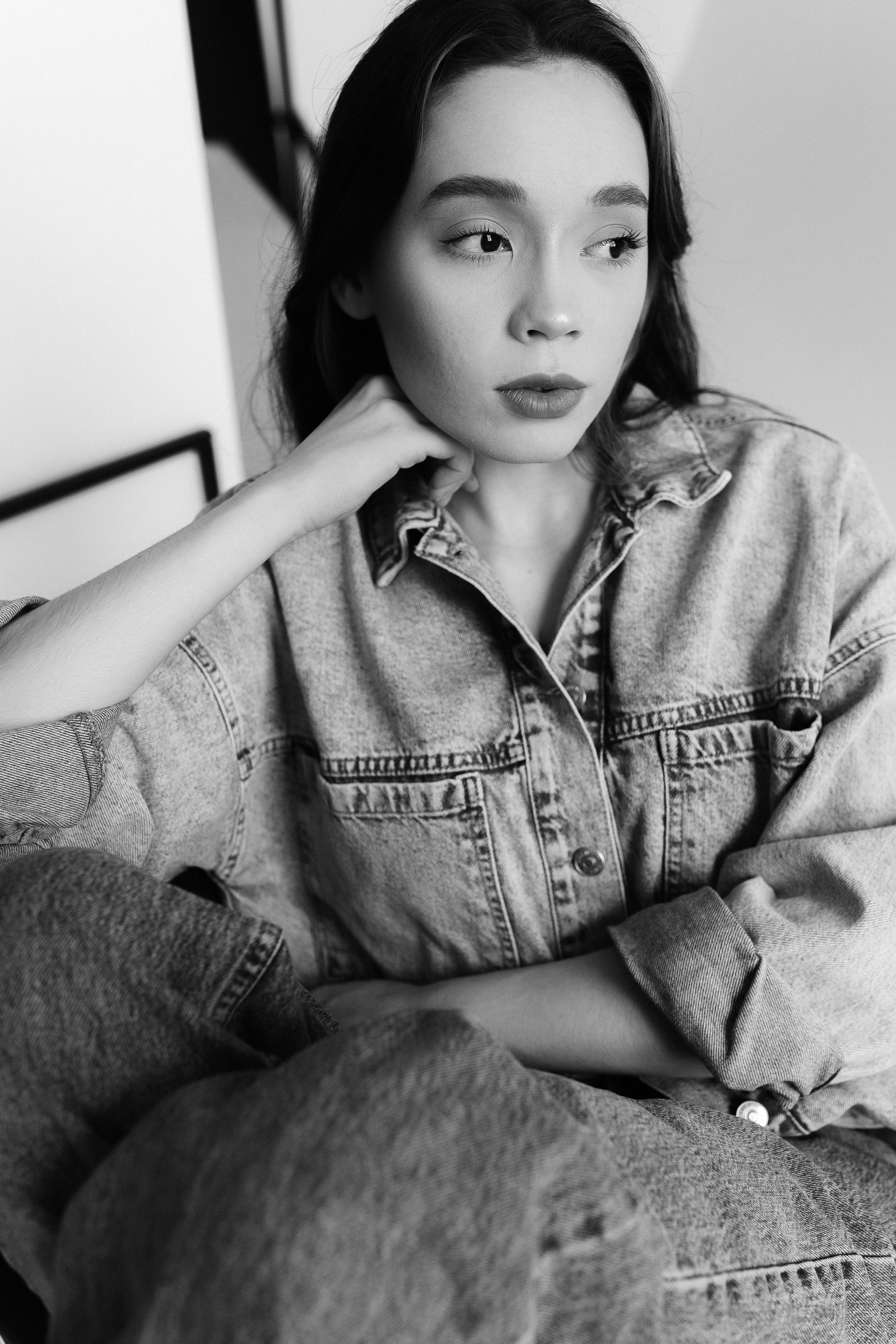 A woman in a denim jacket sitting on a chair · Free Stock Photo