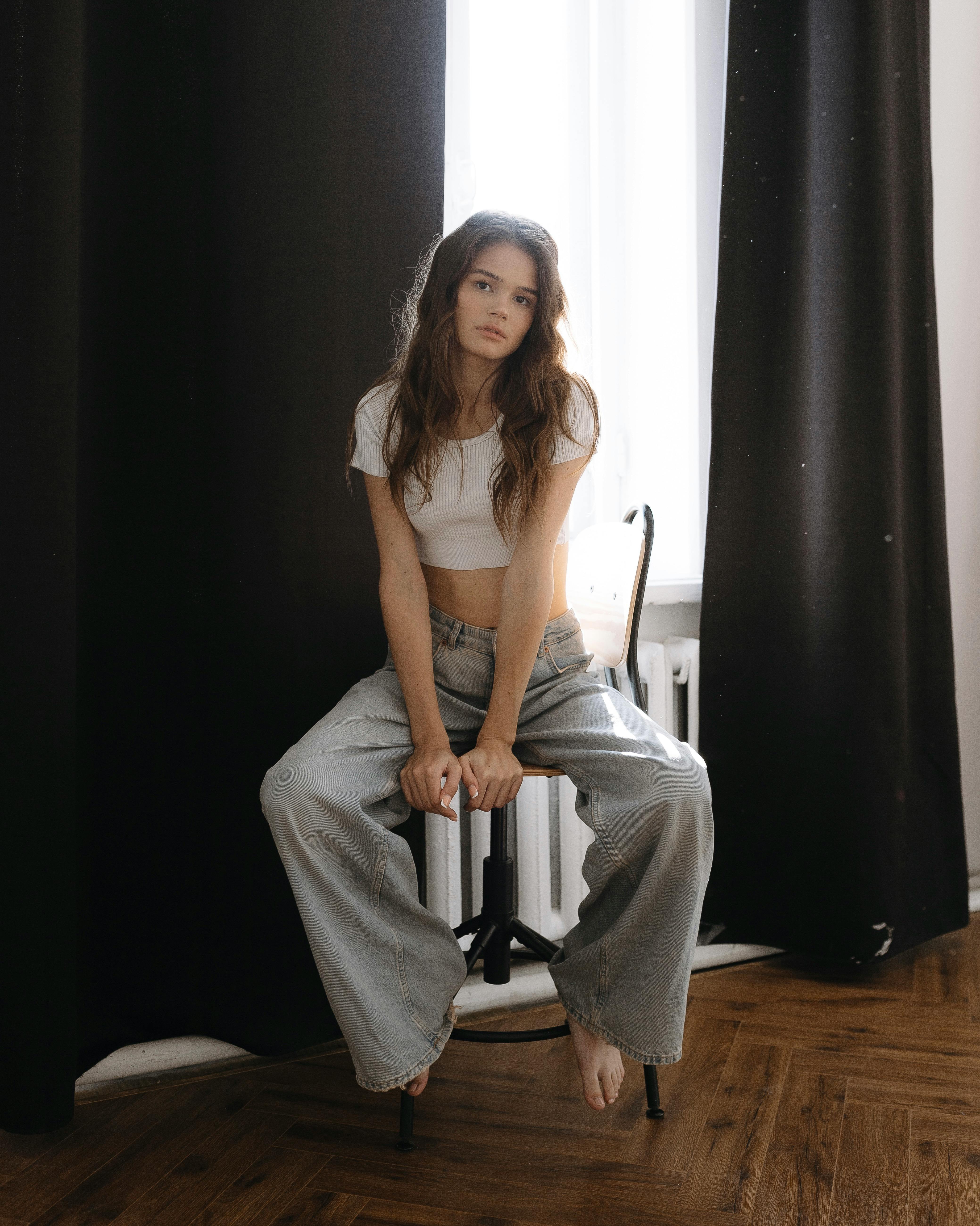 a woman sitting on a chair in a room