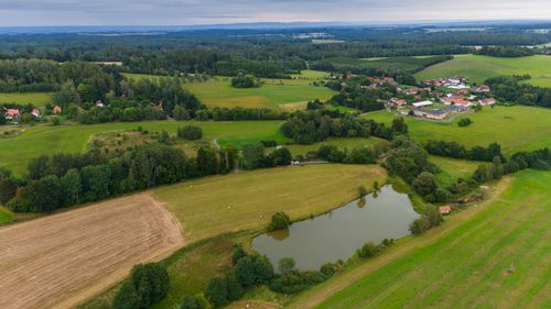Free Scenic aerial view of Zbraslavice farmlands and village with lush greenery and pond. Stock Photo