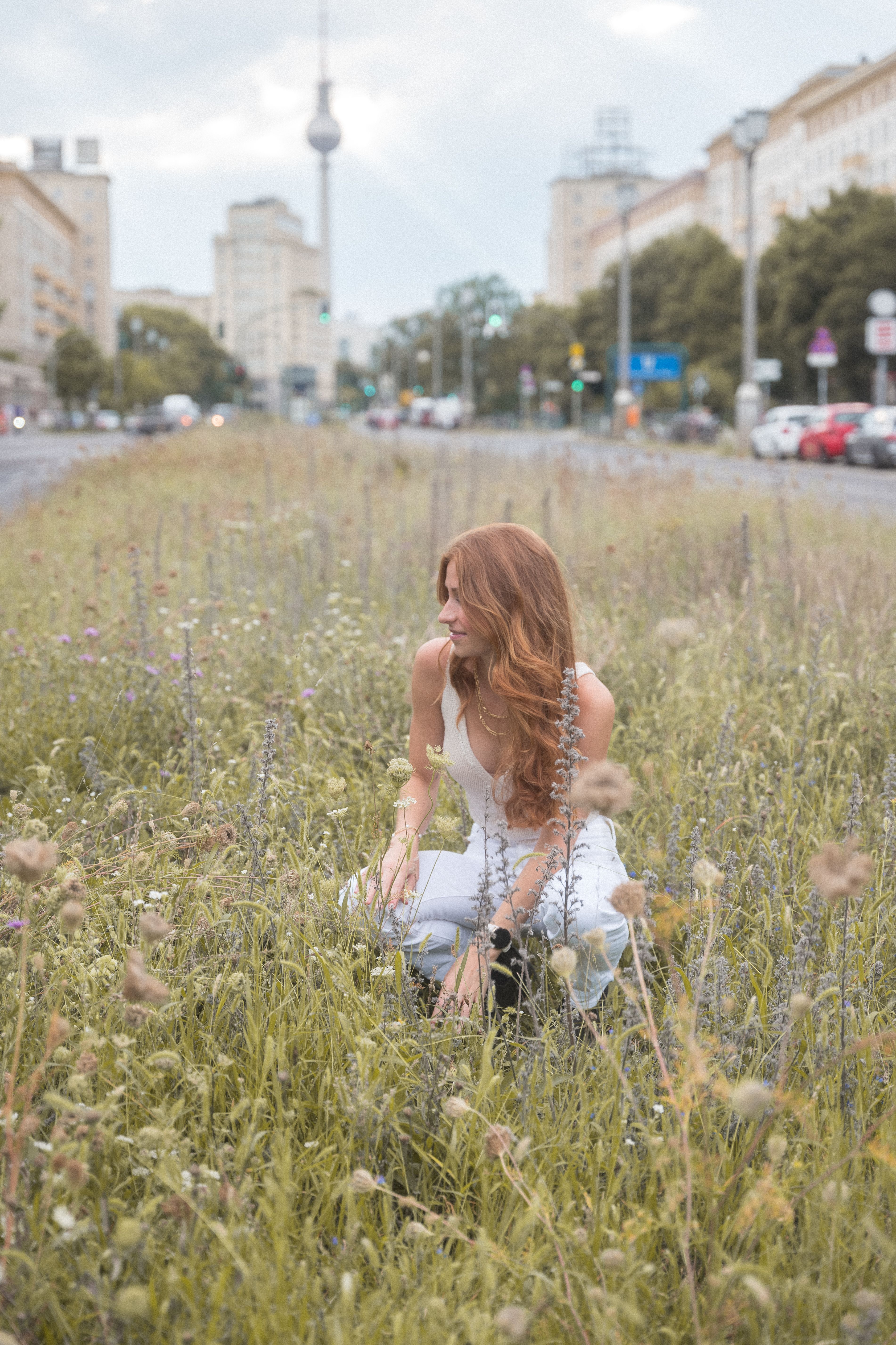 A woman sitting in a field of tall grass · Free Stock Photo