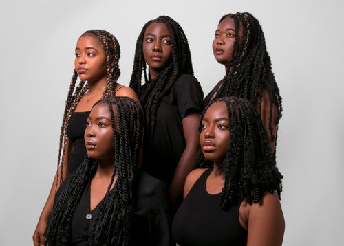 Free A compelling portrait of five stylish black women showcasing dreadlocks and modern fashion. Stock Photo