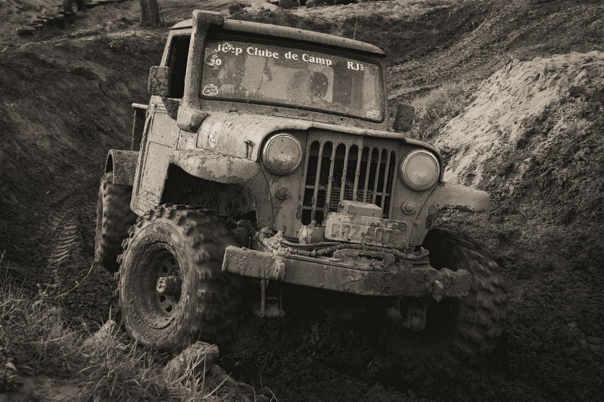 Older Jeep on a muddy trail