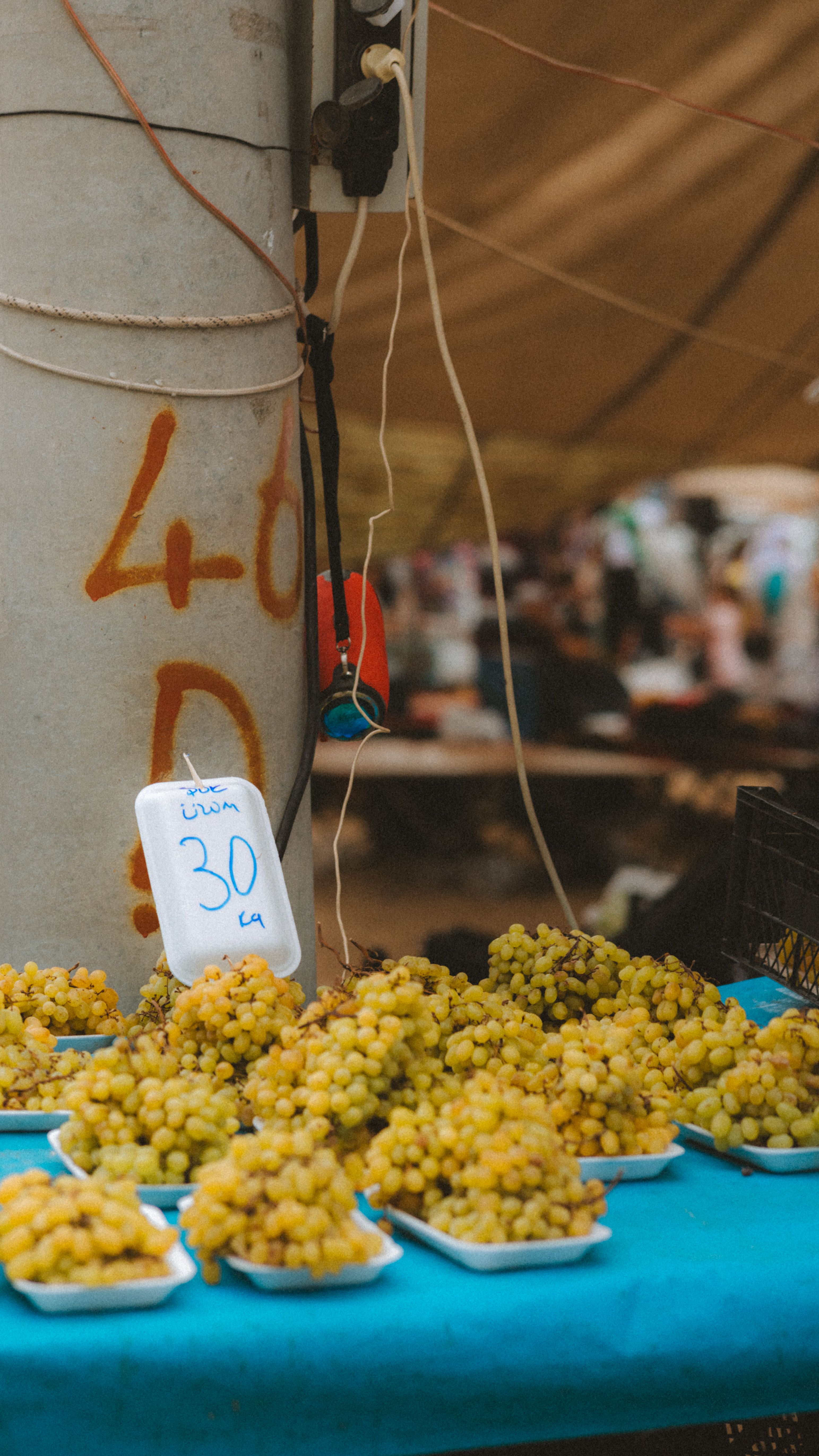 Bright, fresh grapes for sale at an outdoor market stall, showcasing local produce