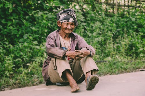 Man Sitting On Ground