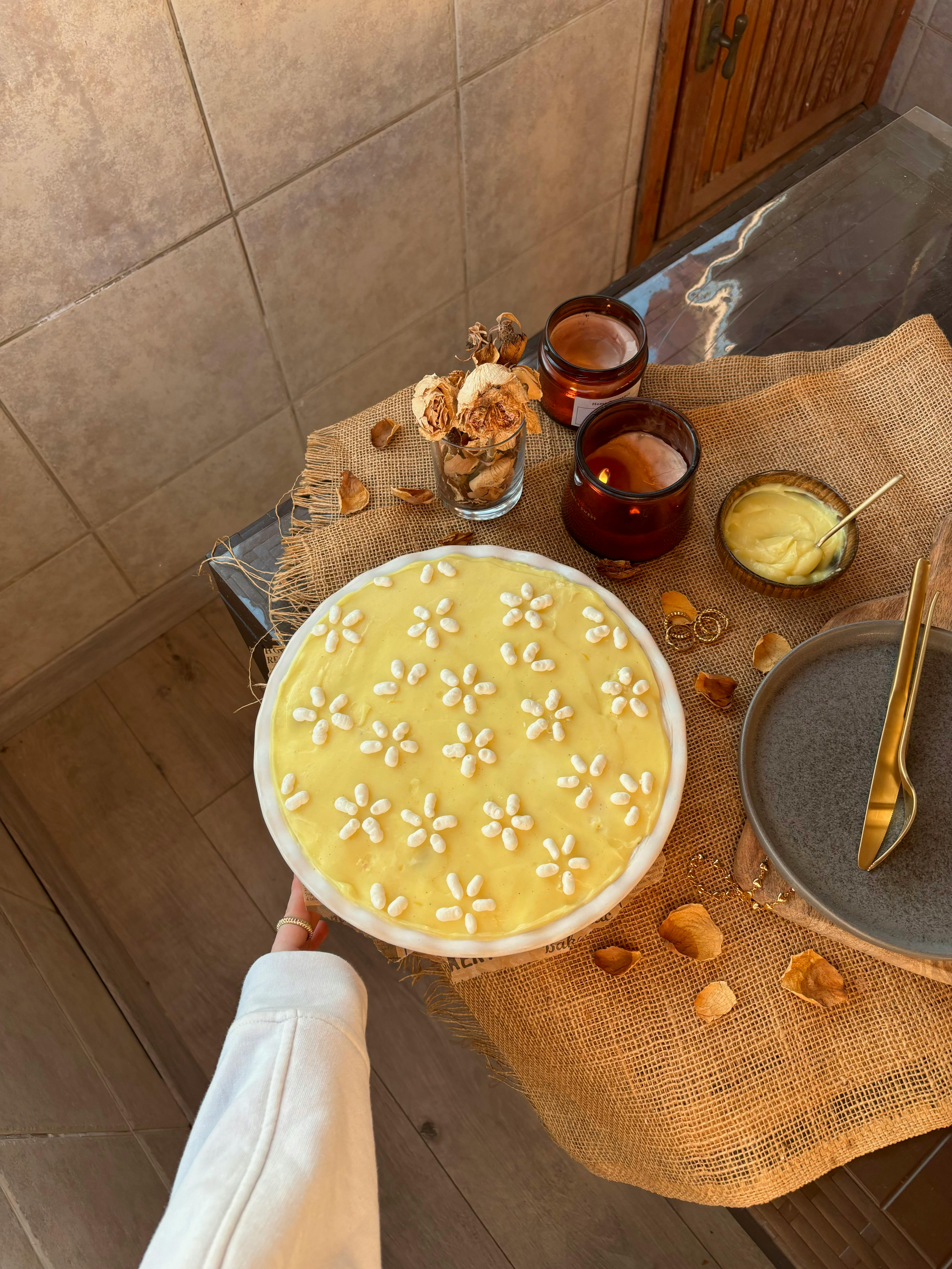 Homemade lemon tiramisu with daisies on a rustic table in İstanbul, Türkiye.