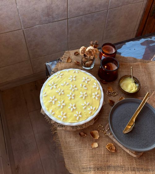 Free A beautifully decorated lemon pie on a rustic table setting, perfect for dessert inspiration. Stock Photo