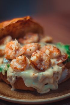 Tasty shrimp sandwich with creamy sauce, perfect for a savory meal or snack.