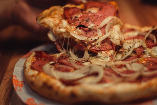 Savory salami and onion pizza served hot with melted cheese, perfect for lunch or dinner.