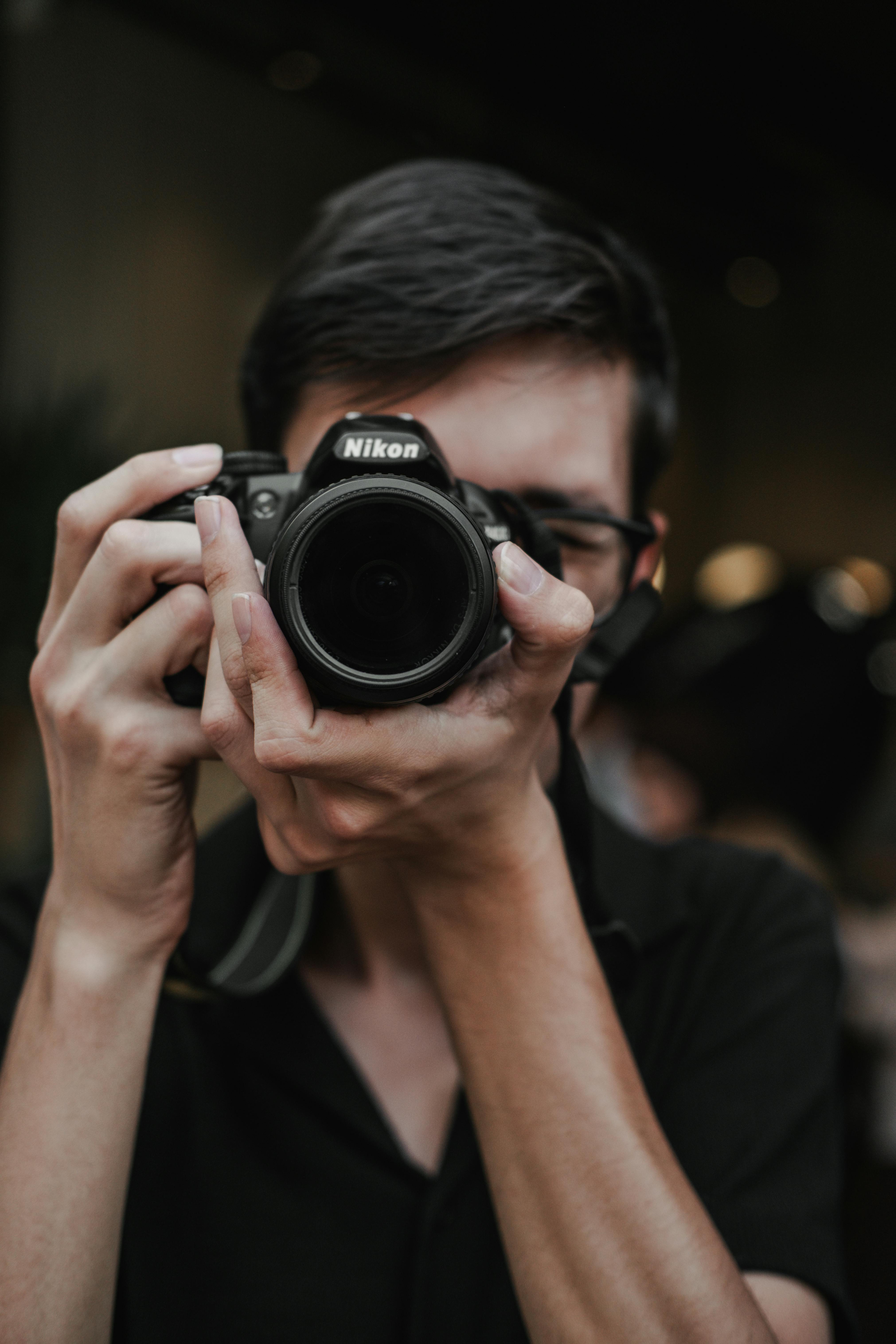 a man holding a camera in front of his face