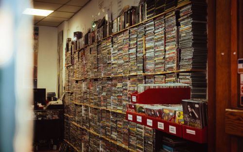 Free Wall of CDs in a vintage Madrid store showcasing music and retail culture. Stock Photo