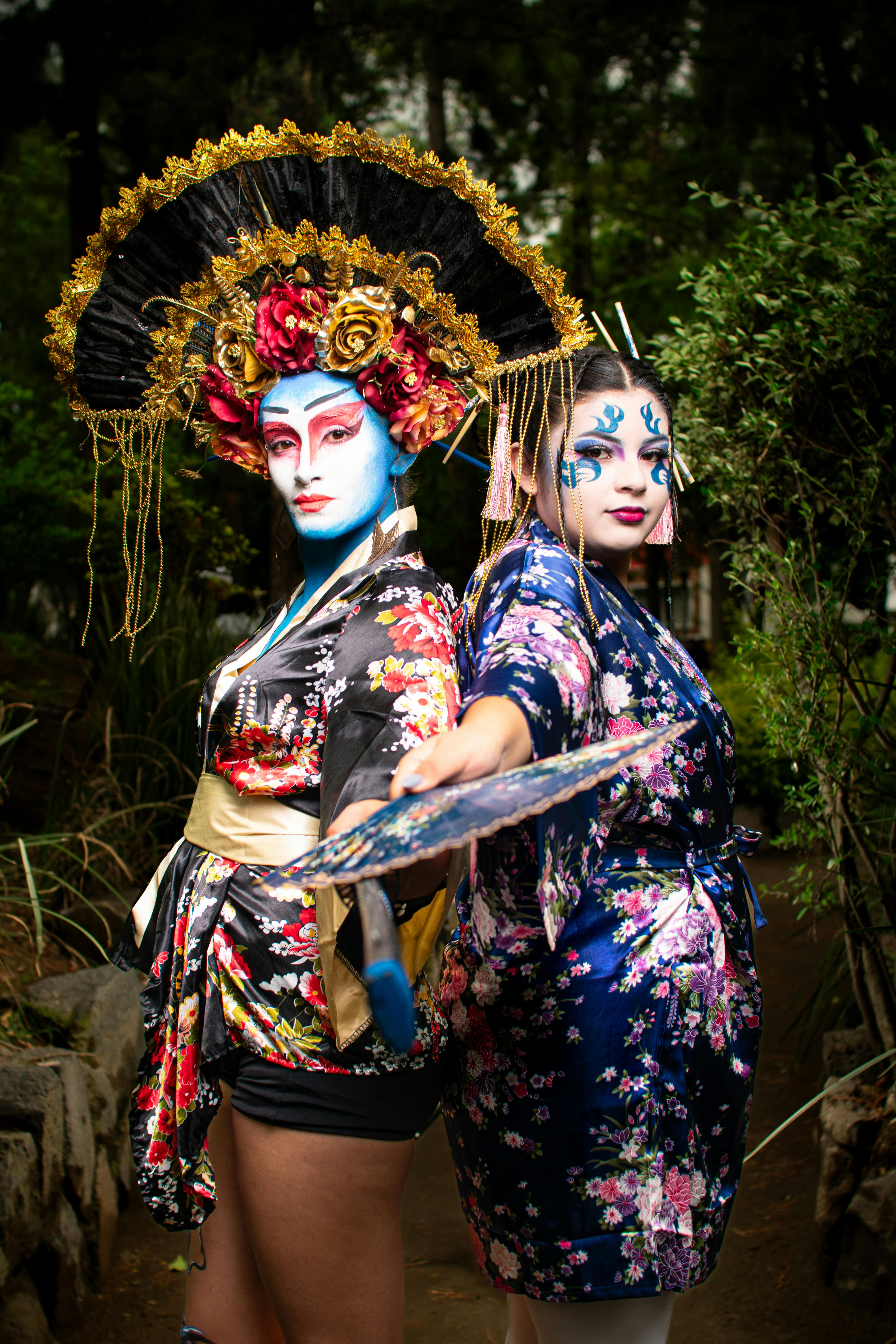 Free Vibrant image of two women in traditional theatrical costumes and makeup, outdoors. Stock Photo