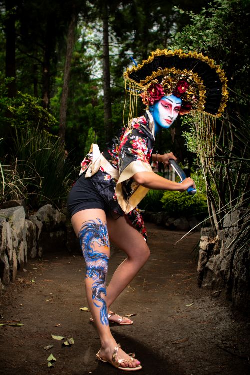 Free Creative street performance featuring a geisha-inspired dancer with traditional makeup and attire in an outdoor setting. Stock Photo