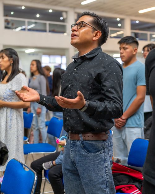 Free A group of diverse individuals engaged in prayer at a church in Mexico City, showcasing community and faith. Stock Photo