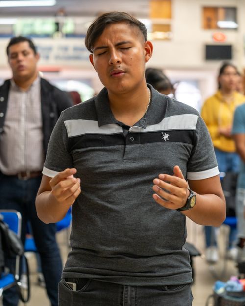 Free Young man with closed eyes praying in a church setting, Ciudad de México, CDMX, México. Stock Photo
