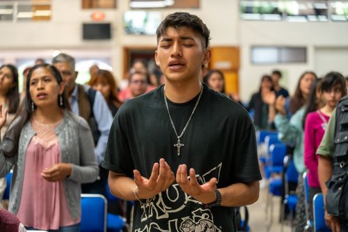 Free A diverse group of people engaging in prayer during a religious service in Ciudad de México, México. Stock Photo