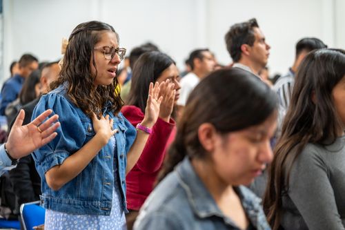 Free Adults gathered in prayer during a church service in Ciudad de México, México. Stock Photo