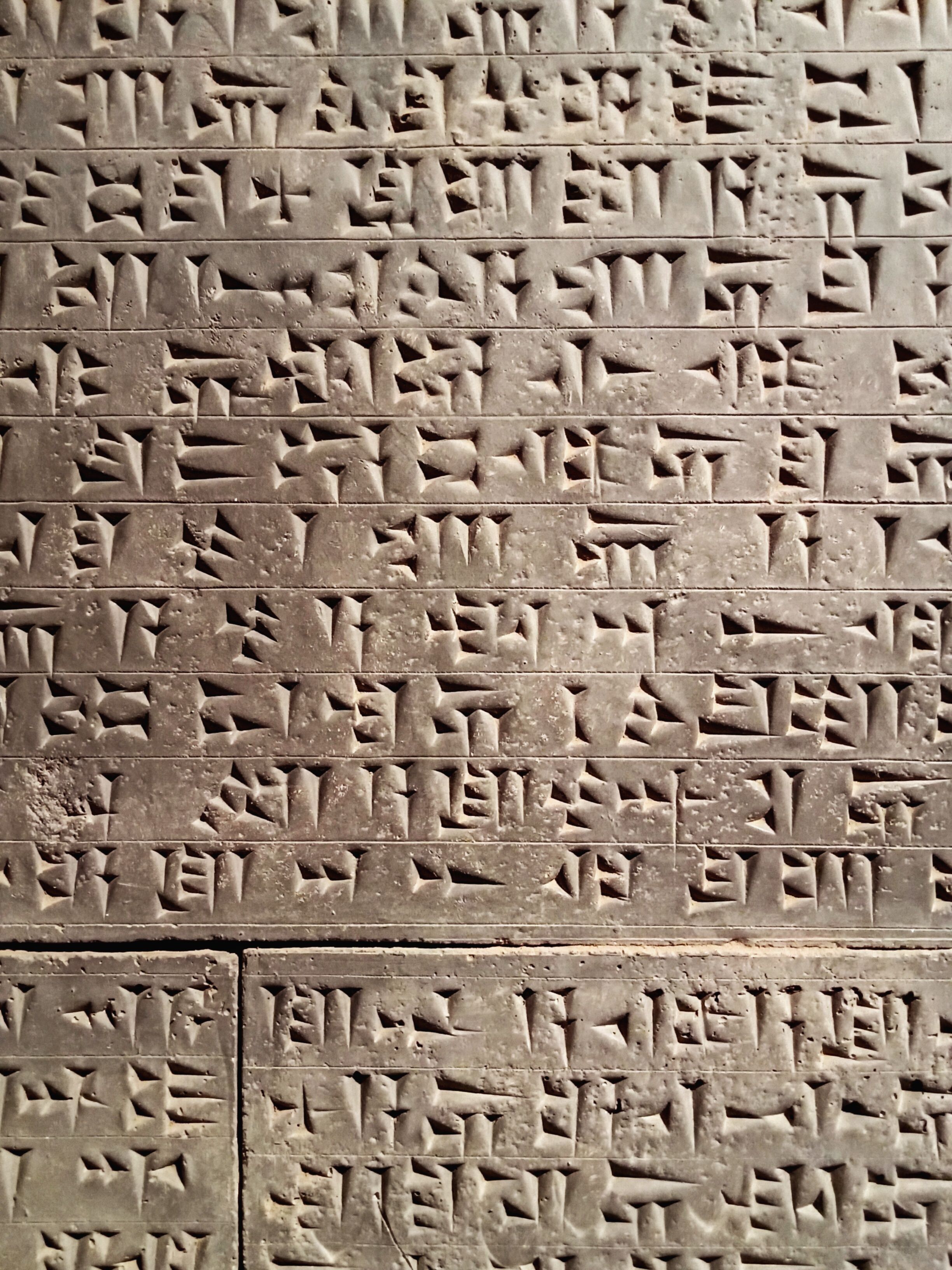 Close-up of ancient cuneiform script on a stone tablet, showcasing Mesopotamian writing.