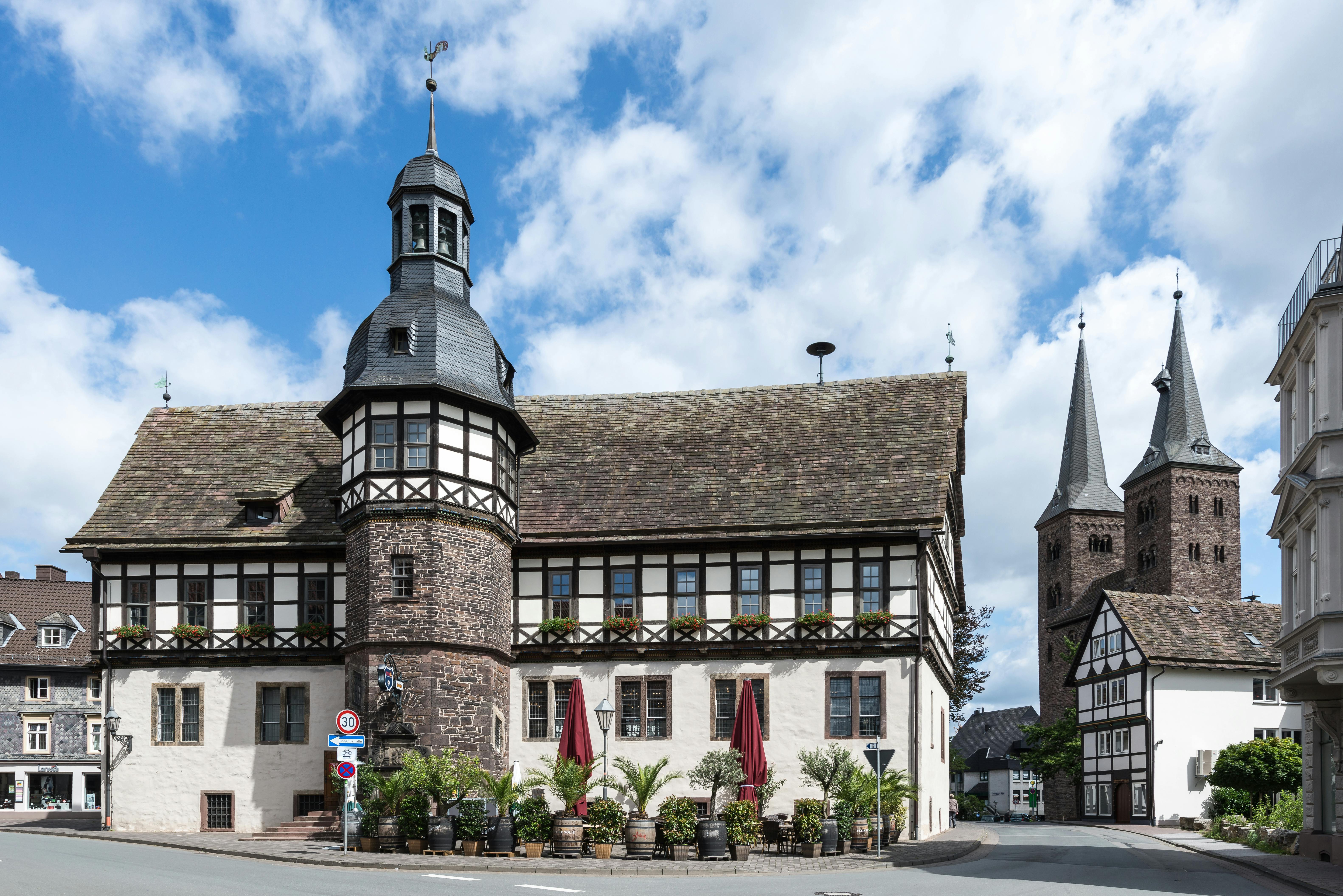 Classic architectural view of Höxter's old town hall and church under a bright sky.