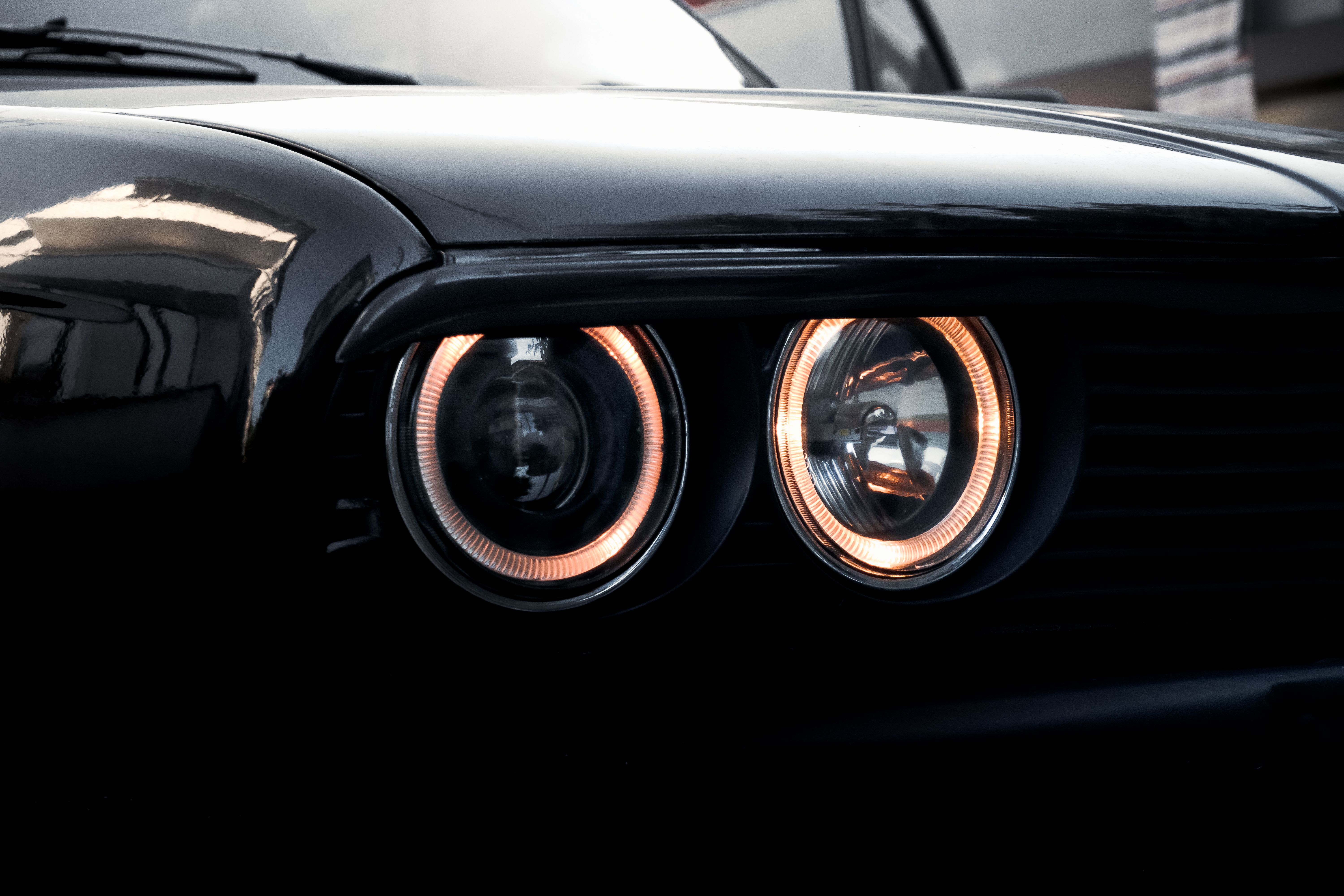 A close-up of classic car headlights with a glossy finish, showcasing vintage design.