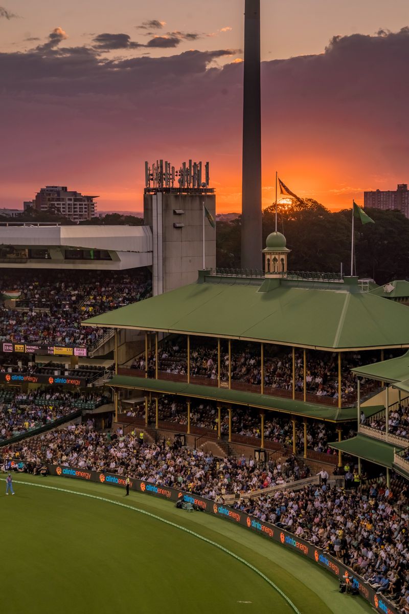 Bustling cricket stadium crowd during dusk with vibrant atmosphere