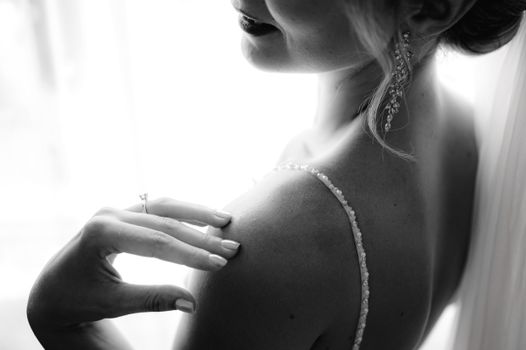 Black and white photo capturing a woman's elegant pose and soft expression.