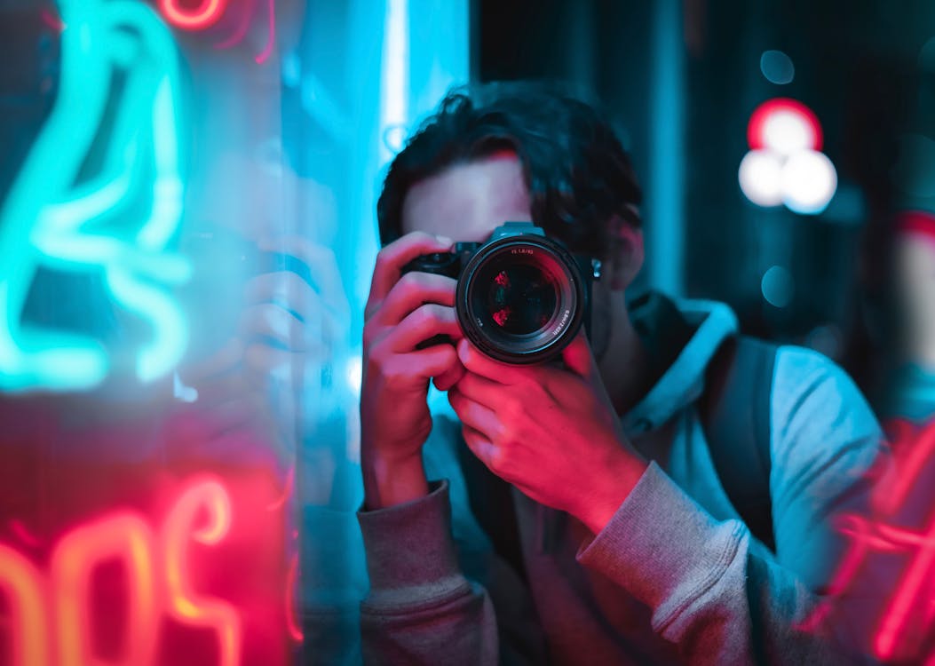 Free Photo of a Man Using a Black Camera Stock Photo