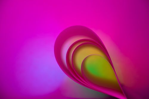 Free Vibrant abstract image of folded paper with dynamic colors and curves, creating a modern, artistic visual. Stock Photo
