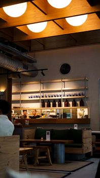 Cozy café interior featuring wood accents, ambient lighting, and a stylish counter setup.