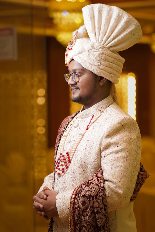 Free Portrait of a groom in traditional Bangladeshi attire at a wedding ceremony indoors. Stock Photo