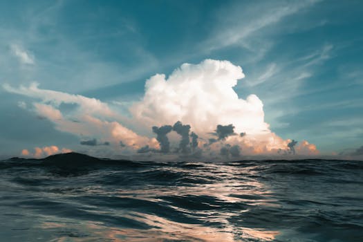 Stunning seascape capturing a dramatic sunset over the ocean with towering clouds in Navarre, FL.