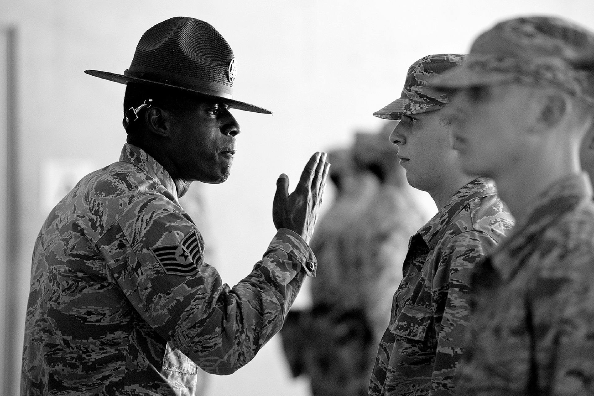 soldier-and-black-dog-cuddling-free-stock-photo