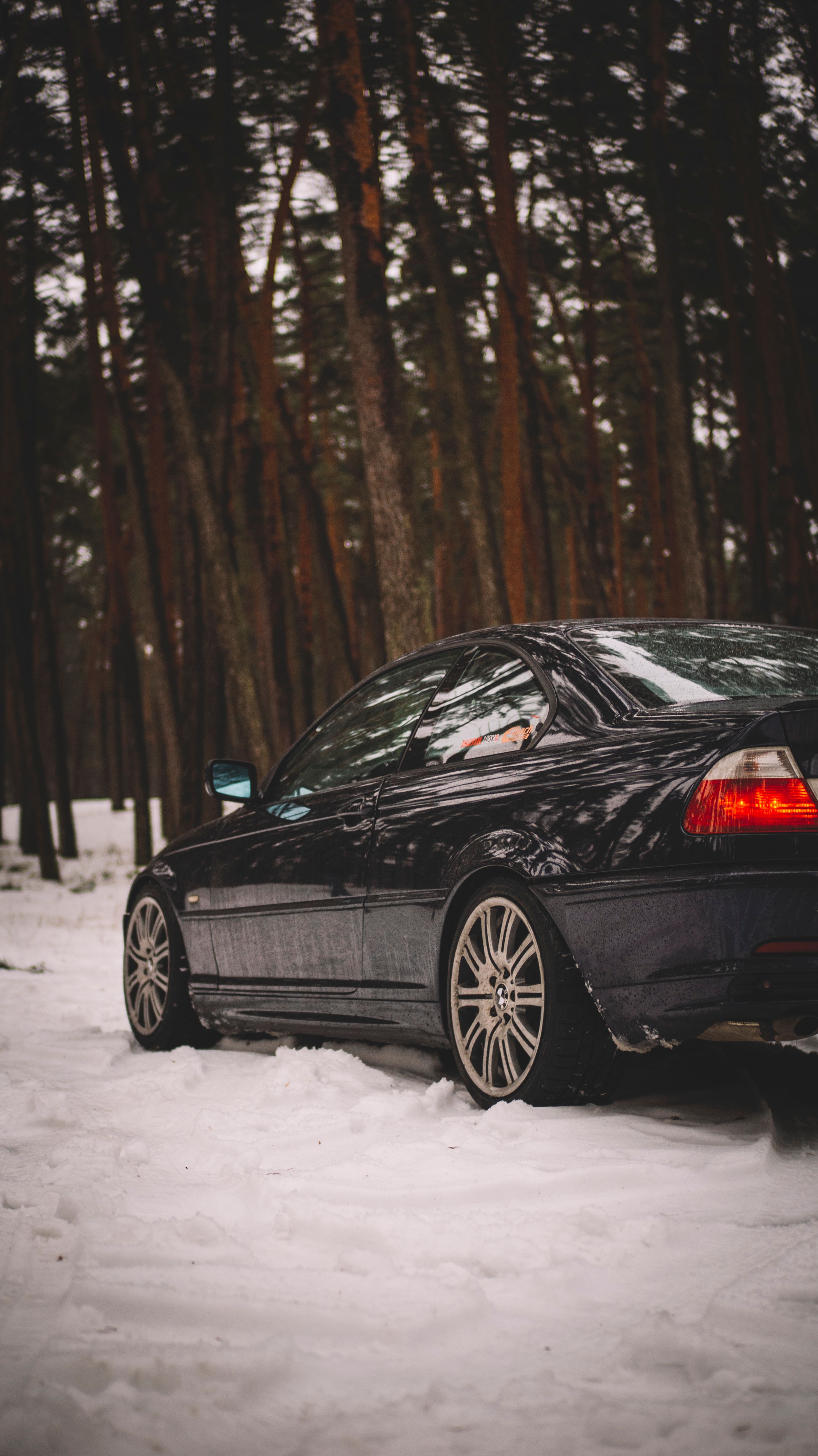 A black car parked in the snow · Free Stock Photo