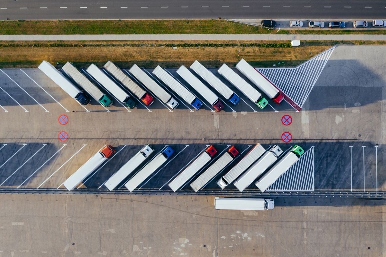 Aerial view of a row of lorries parked in a yard