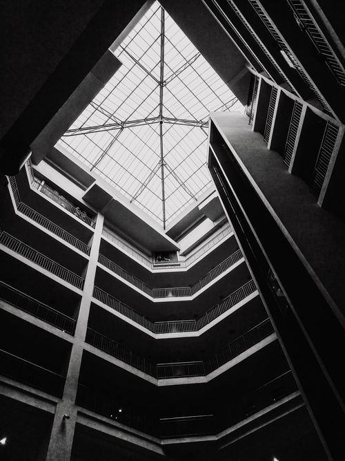 Free Black and white image of a modern atrium at the Nairobi shopping mall showcasing geometric architecture. Stock Photo